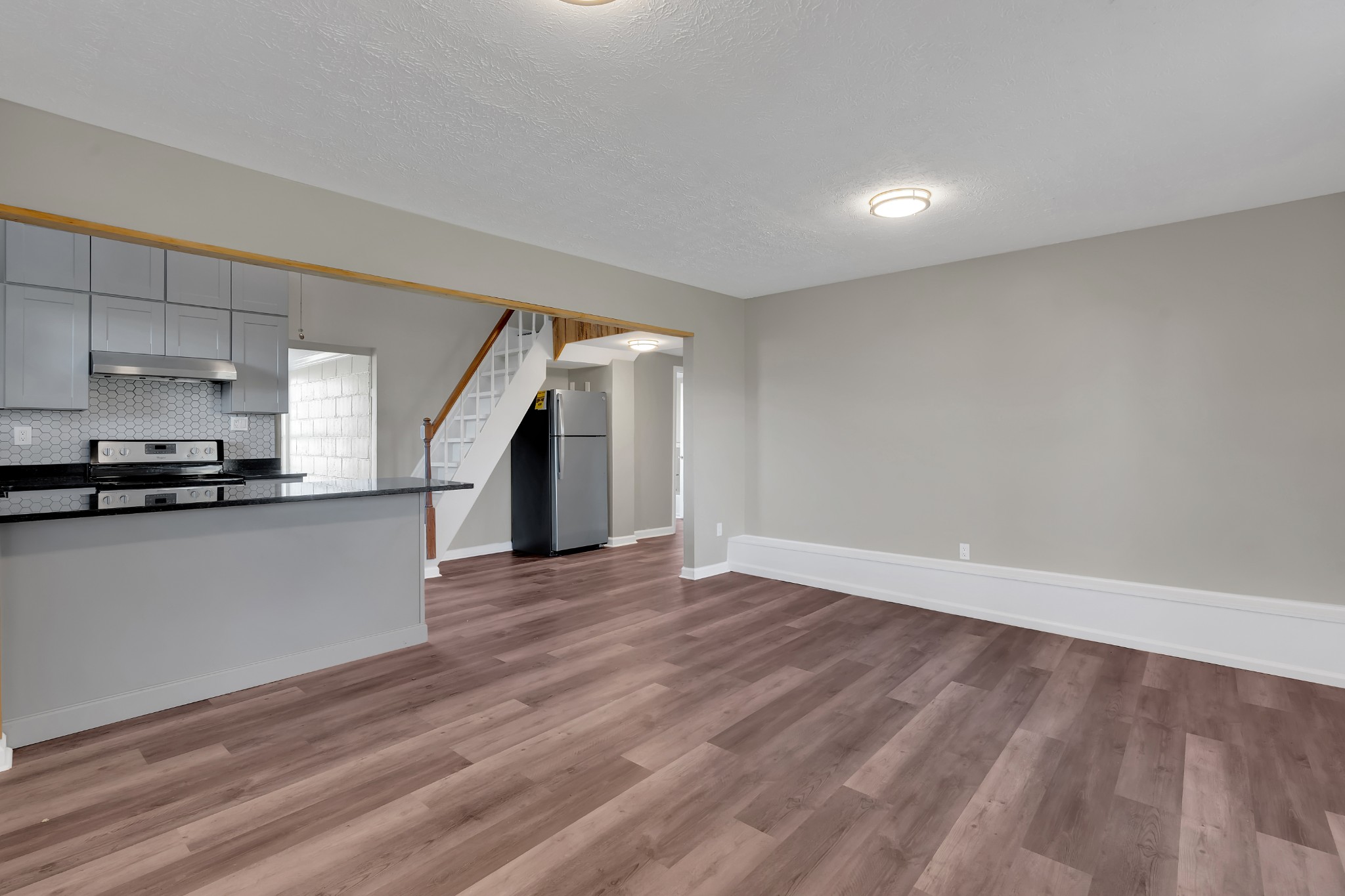 490 Shady Grove Road Manchester, TN 37355 - Photo 31 of 49 a view of empty room with wooden floor and kitchen