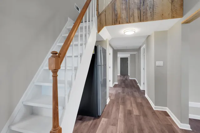 a view of entryway and hall with wooden floor