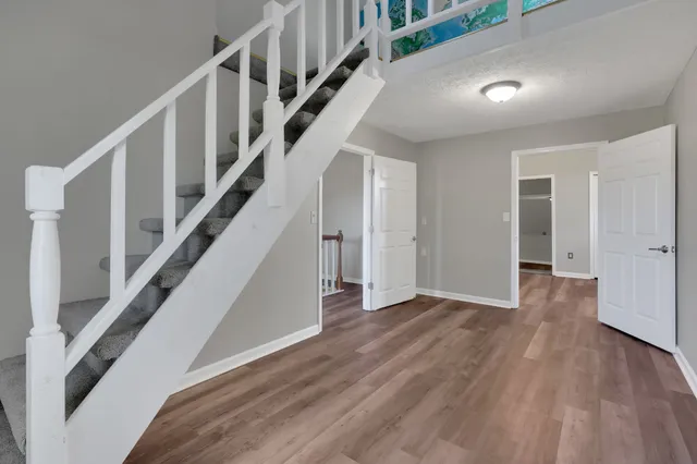 a view of staircase with wooden floor and stairs