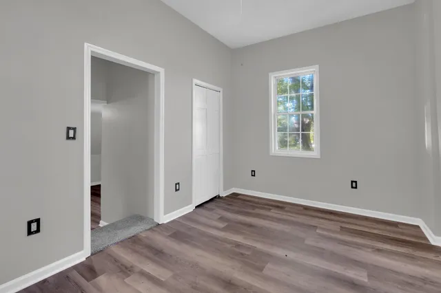 a view of room with window and hardwood floor