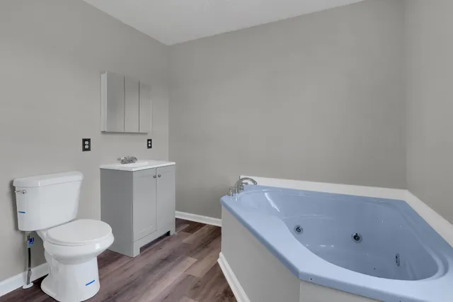 a white bath tub sitting next to a white toilet