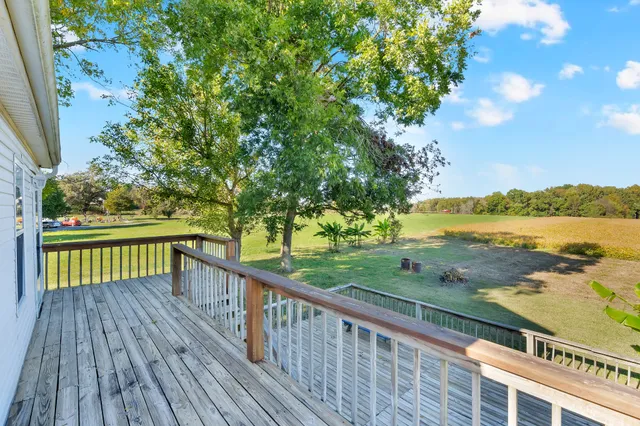 a view of balcony with wooden floor and fence