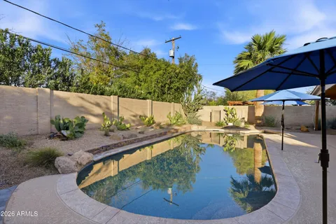 a view of a backyard with furniture and a garden
