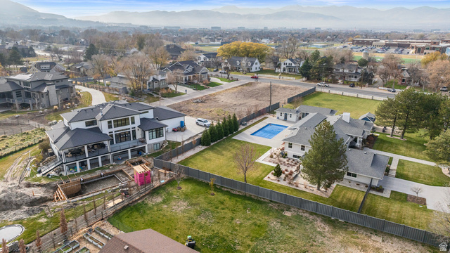 12959 South Fort Street Draper, UT 84020 - Photo 8 of 20 Aerial perspective of suburban area featuring a mountainous background and a pool