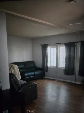 a living room with furniture and a hard wood floor