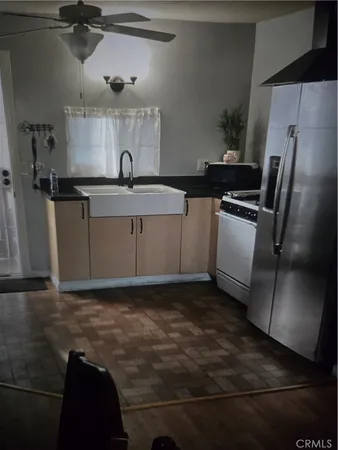 a kitchen with sink refrigerator and stove