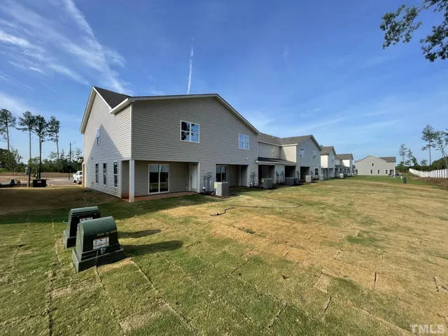 a house view with swimming pool in front of it