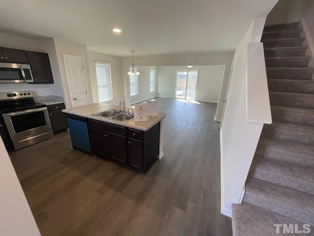 a kitchen with stainless steel appliances granite countertop a sink counter space and cabinets