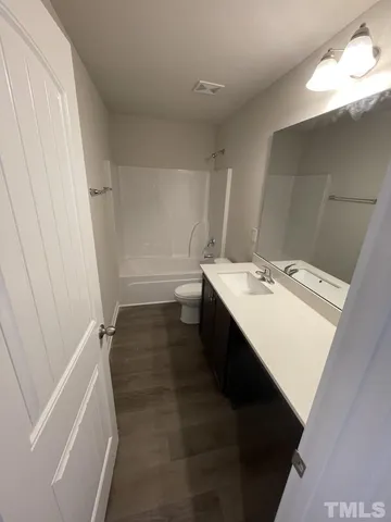 a bathroom with a sink a mirror and a shower
