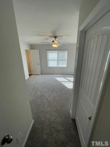 a view of an empty room and a window