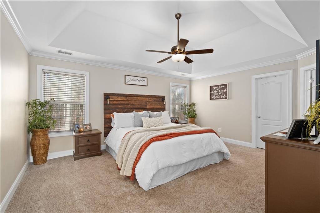 129 Boulder View Court Dallas, GA 30157 - Photo 20 of 43 a bedroom with a bed a ceiling fan and a couch
