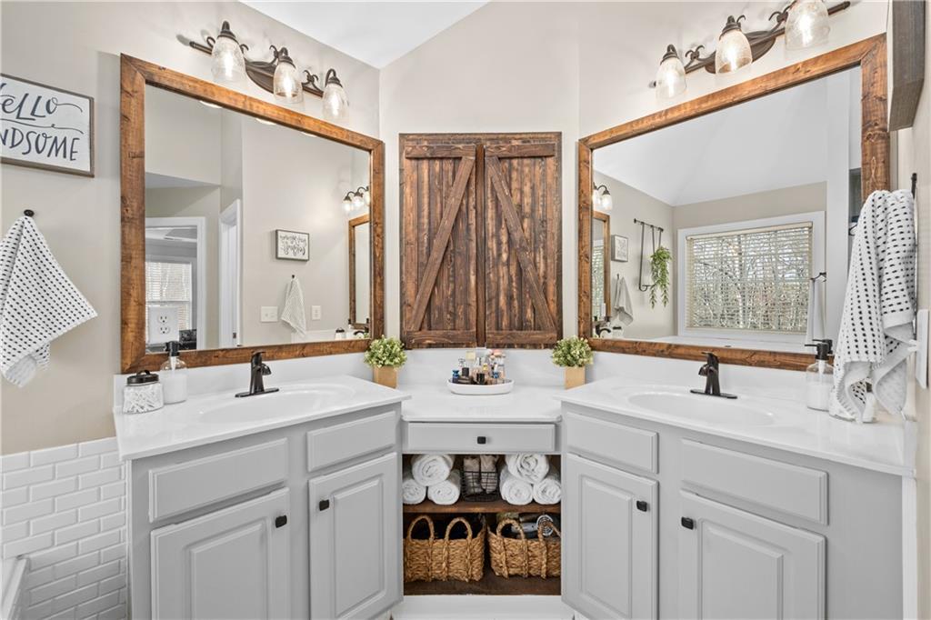 129 Boulder View Court Dallas, GA 30157 - Photo 23 of 43 a bathroom with a sink and a mirror