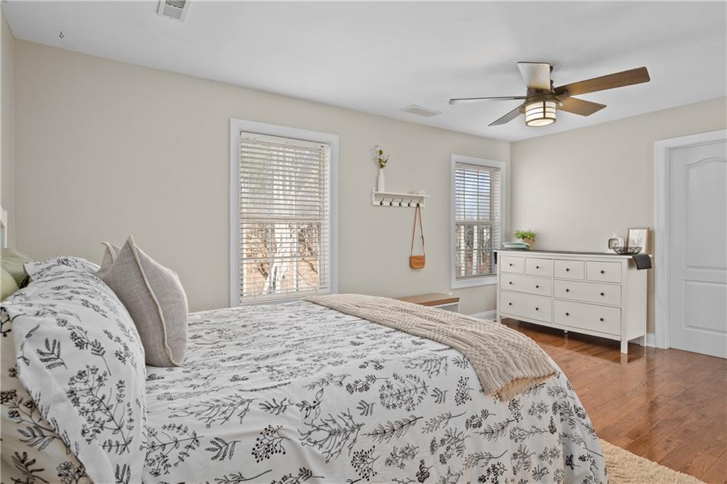 129 Boulder View Court Dallas, GA 30157 - Photo 26 of 43 a bedroom with a bed and wooden floor