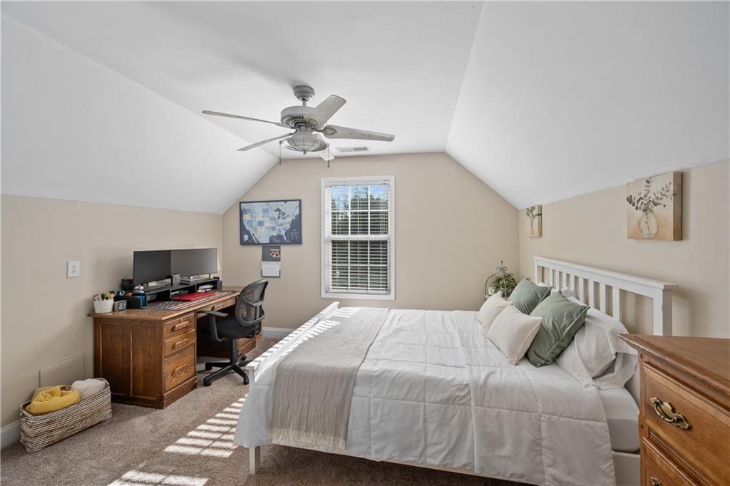 129 Boulder View Court Dallas, GA 30157 - Photo 29 of 43 a bedroom with a bed and a chandelier