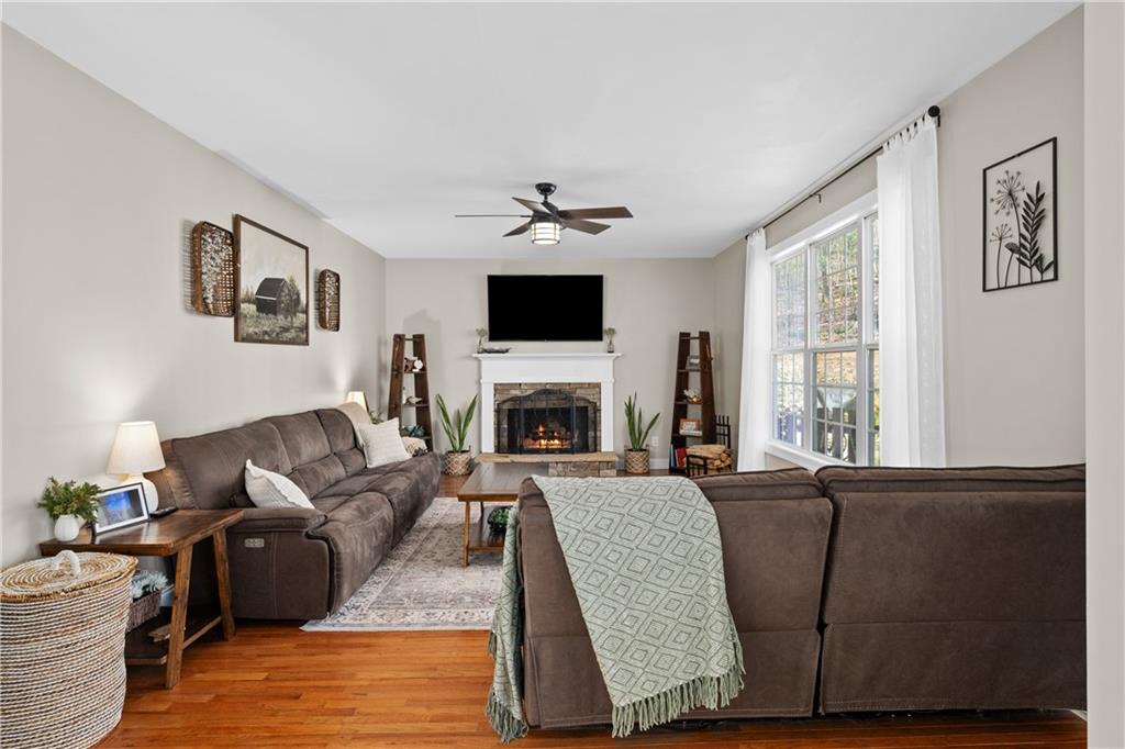 129 Boulder View Court Dallas, GA 30157 - Photo 4 of 43 a living room with furniture a fireplace and a flat screen tv