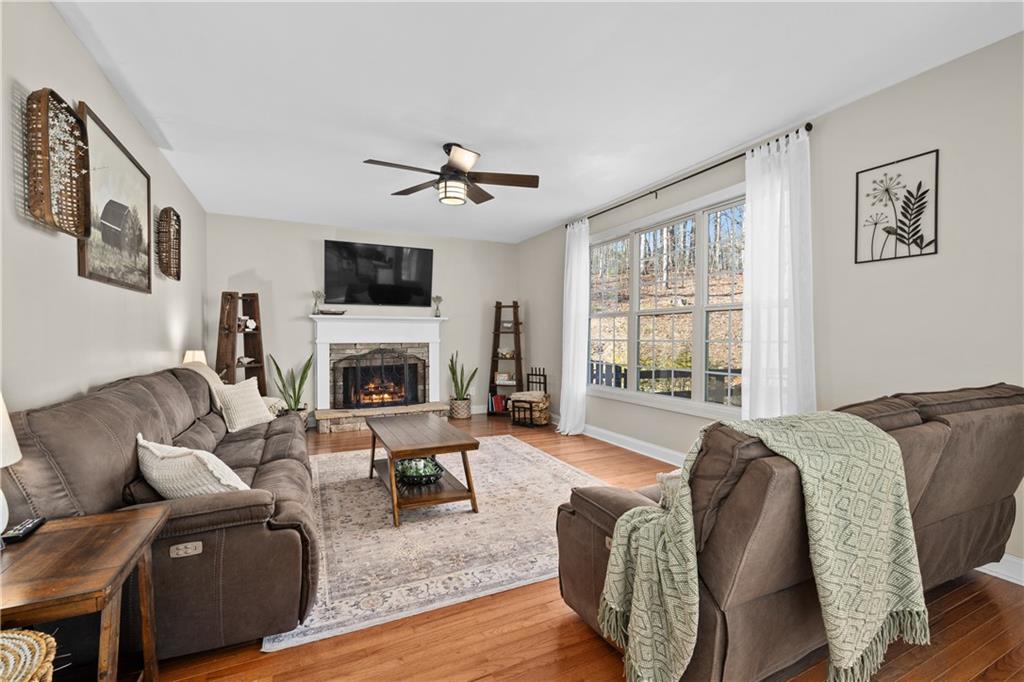 129 Boulder View Court Dallas, GA 30157 - Photo 5 of 43 a living room with furniture a flat screen tv and a fireplace