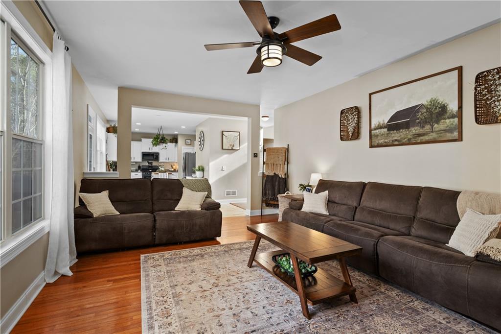 129 Boulder View Court Dallas, GA 30157 - Photo 6 of 43 a living room with furniture a rug and a chandelier