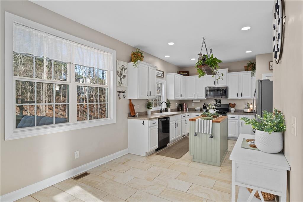 129 Boulder View Court Dallas, GA 30157 - Photo 9 of 43 a kitchen with a refrigerator and a white cabinets