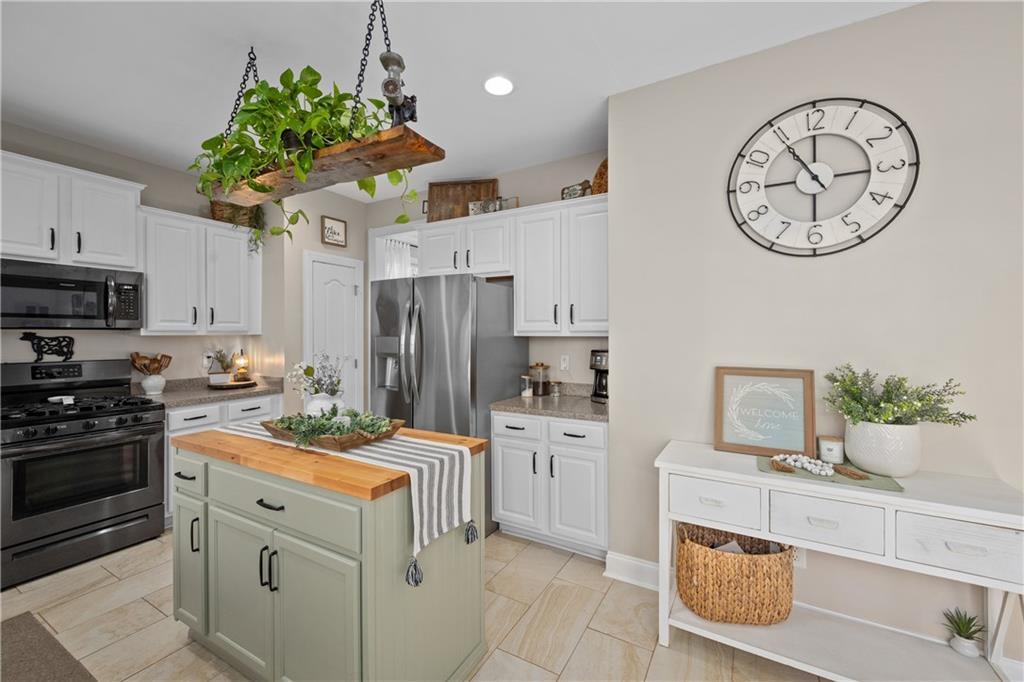 129 Boulder View Court Dallas, GA 30157 - Photo 10 of 43 a kitchen with white cabinets and stainless steel appliances