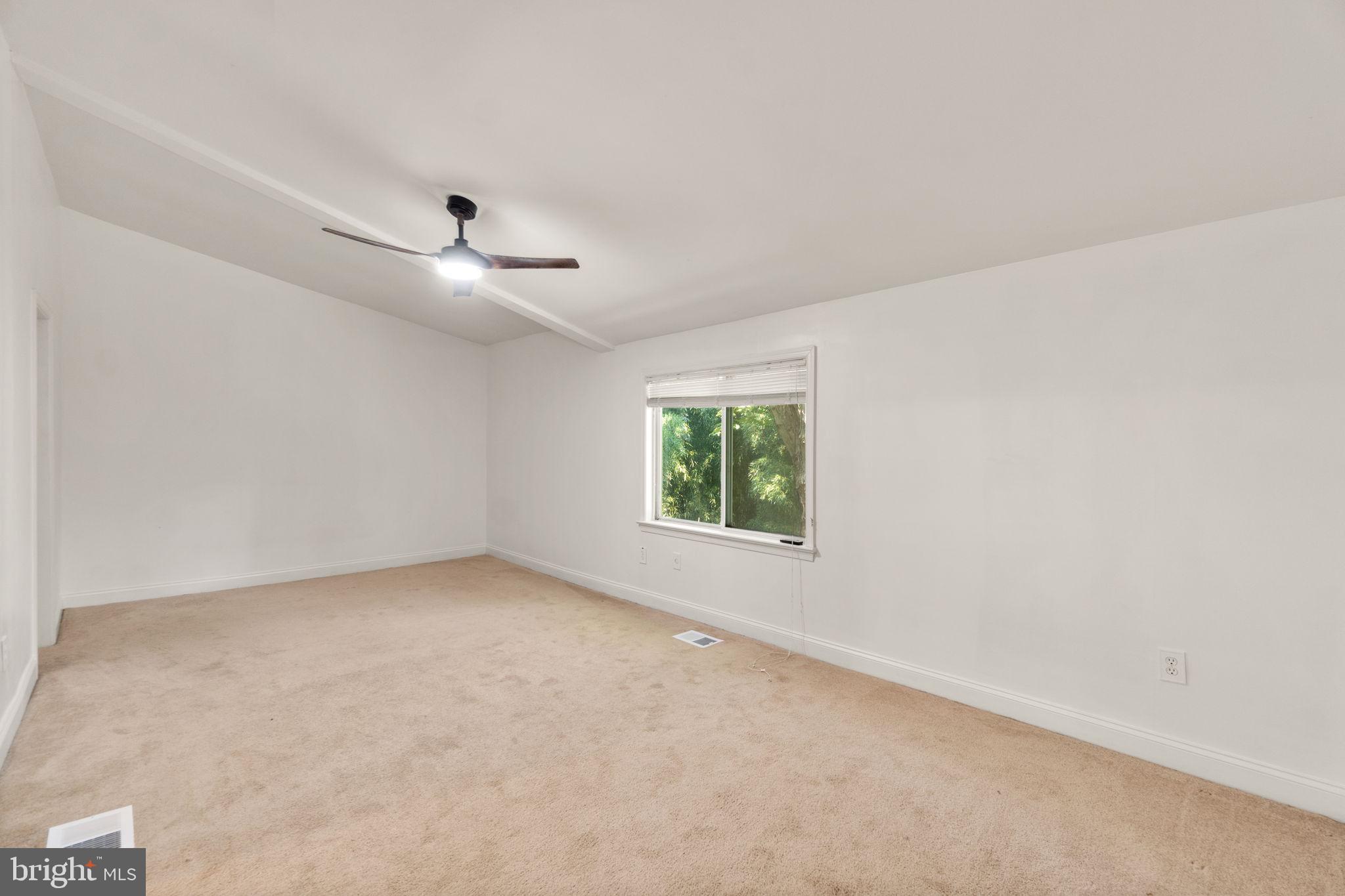 9528 Wandering Way Columbia, MD 21045 - Photo 13 of 29 an empty room with windows and ceiling fan