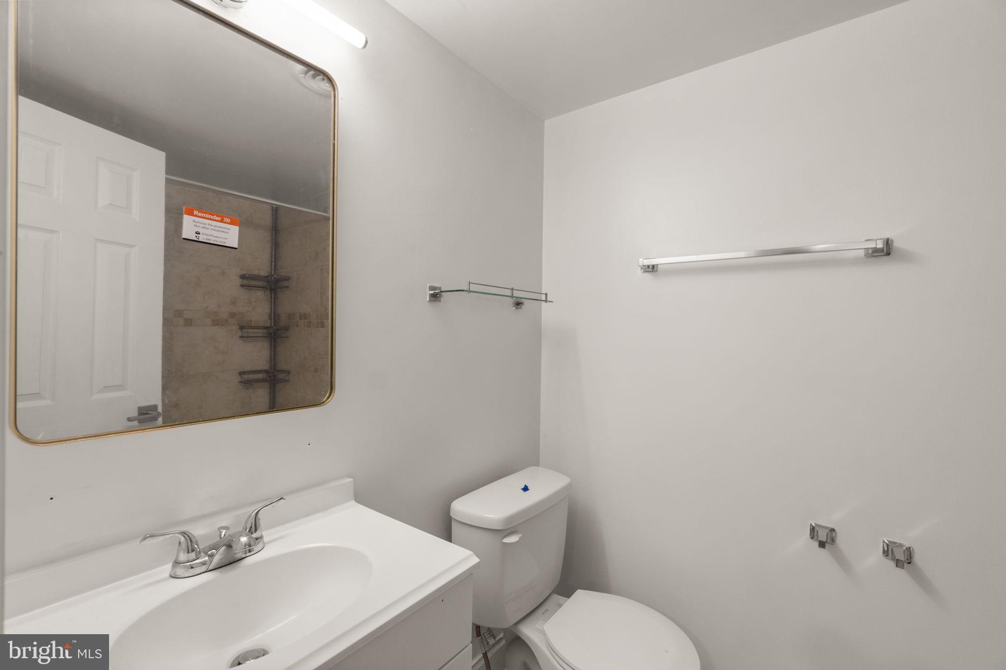 9528 Wandering Way Columbia, MD 21045 - Photo 25 of 29 a bathroom with a sink mirror and toilet