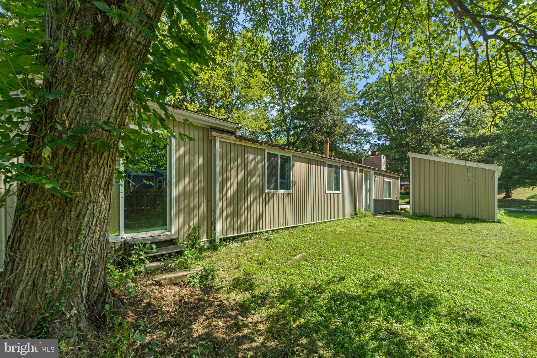 9528 Wandering Way Columbia, MD 21045 - Photo 28 of 29 a backyard of a house with plants and large tree