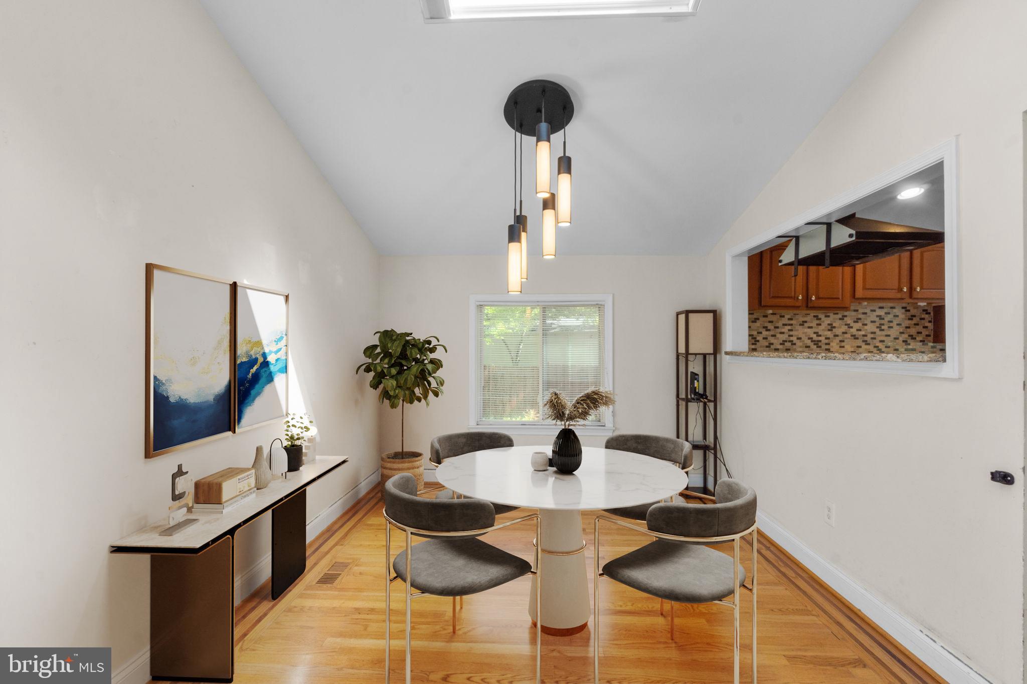 9528 Wandering Way Columbia, MD 21045 - Photo 7 of 29 a view of a dining room with furniture and wooden floor