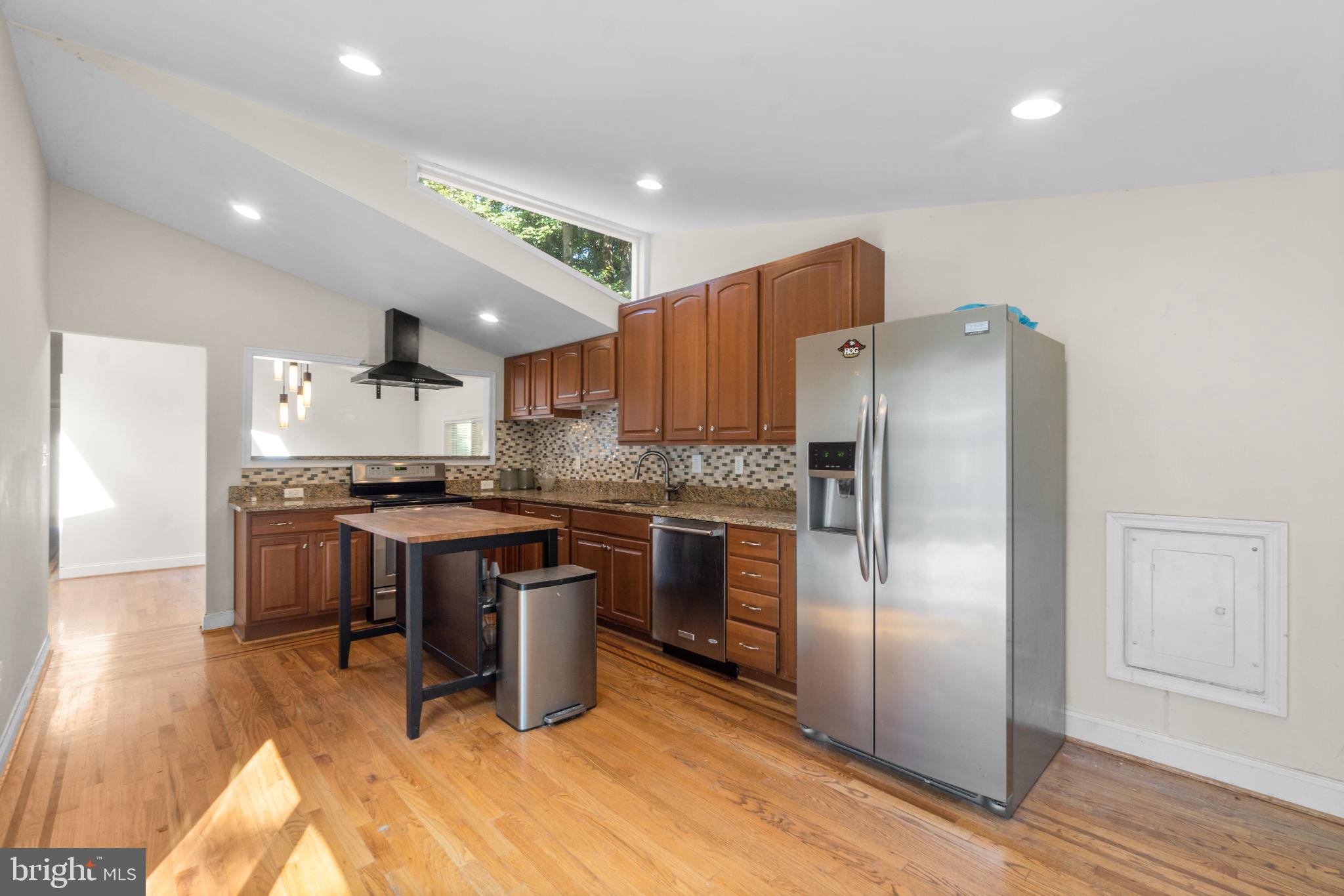 9528 Wandering Way Columbia, MD 21045 - Photo 10 of 29 a kitchen with a refrigerator a sink and a stove top oven