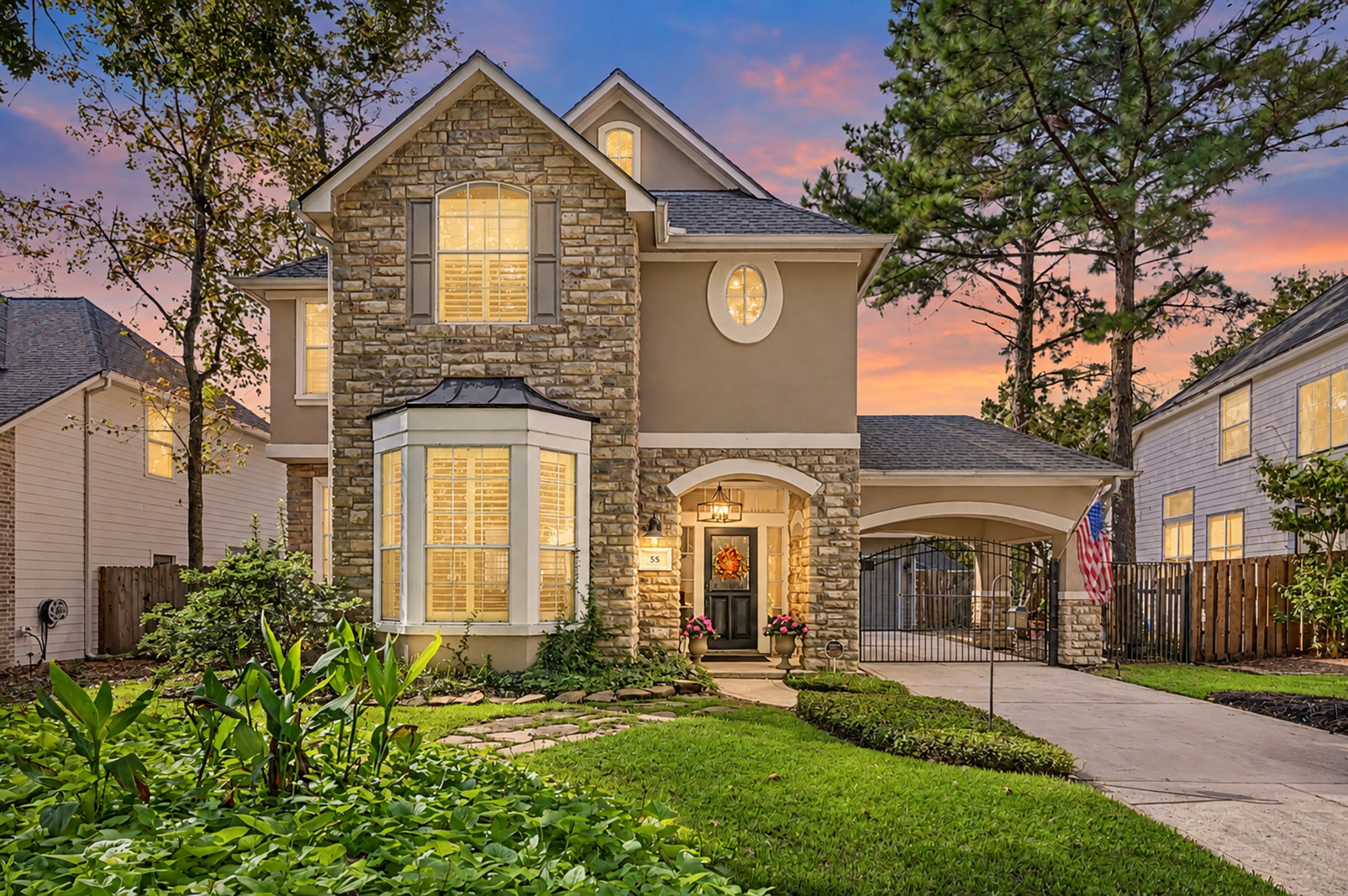 55 South Bethany Bend Circle Spring, TX 77382 - Photo 1 of 28 Exceptional curb appeal welcomes you with timeless stone and stucco, lush landscaping, an elegant arched entry, and a gated porte-cochère—creating a sophisticated sense of arrival.