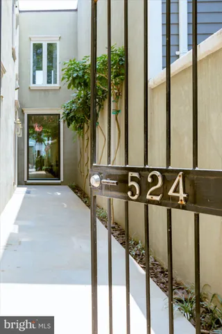 a view of a room with a floor to ceiling window and potted plants