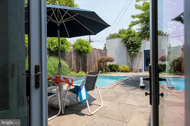 a view of a patio with table and chairs under an umbrella