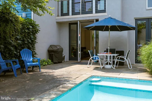 a view of a two chairs under an umbrella in patio