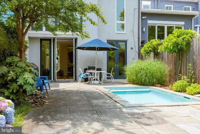 a view of a chair and table in backyard of the house