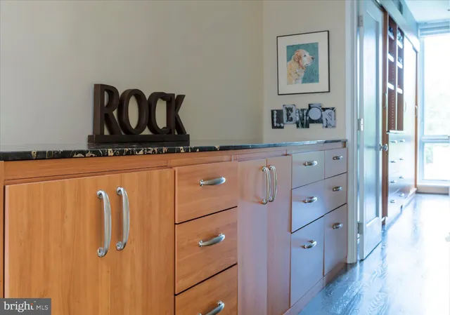 a kitchen with cabinets and wooden floor