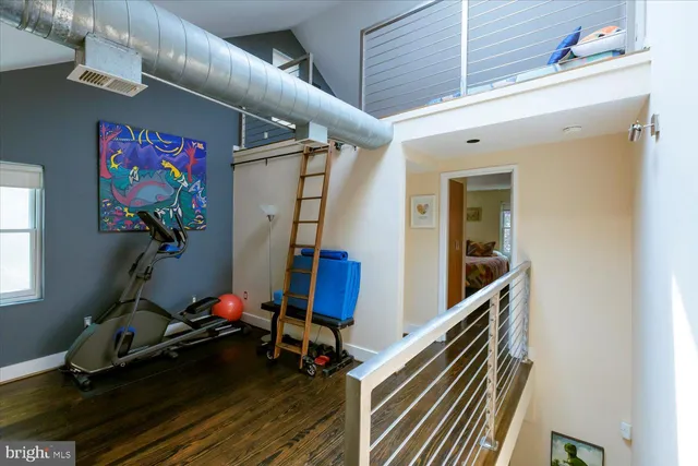 a view of a room with wooden floor and windows
