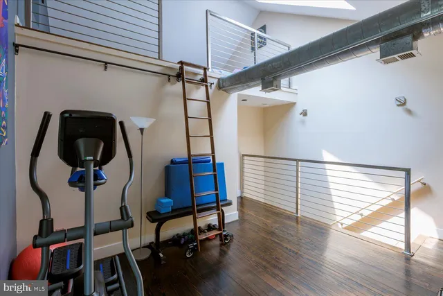 a bedroom with a bed and a potted plant on table