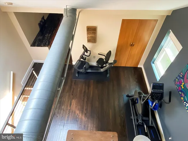 a view of bedroom with a bed and wooden floor