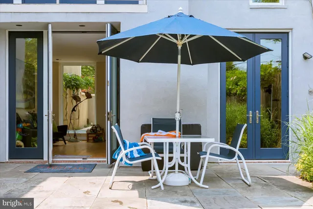 a patio table and chairs under an umbrella