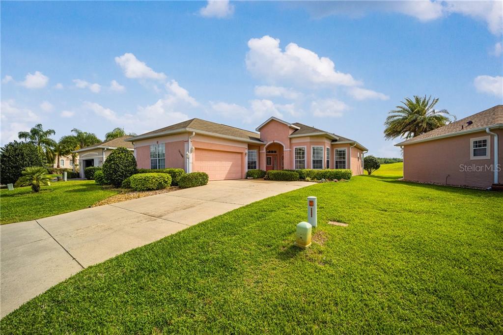 17709 Southeast 121st Terrace Road Summerfield, FL 34491 - Photo 1 of 1 a house view with a garden space