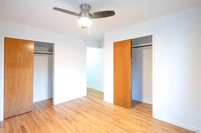 a view of empty room with wooden floor