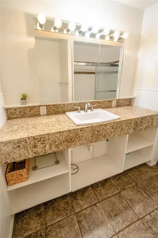 a bathroom with a shower and a wooden floor