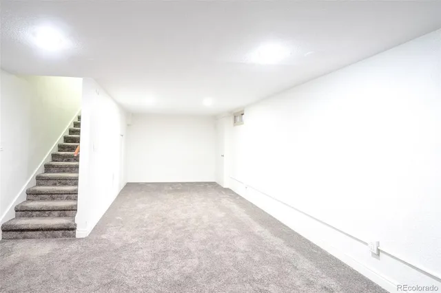 a view of a room with furniture and a flat screen tv