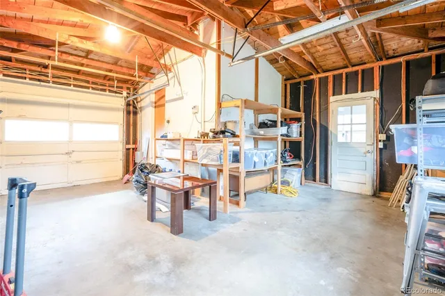 a front view of a house with yard and furniture