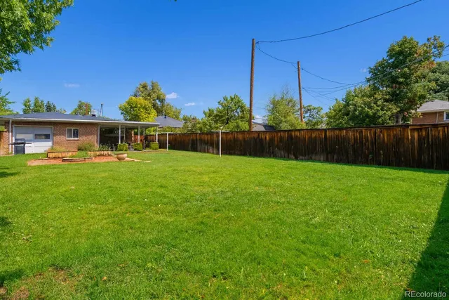 a view of house with backyard space and garden
