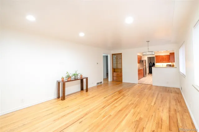 a spacious bedroom with a bed and a dresser