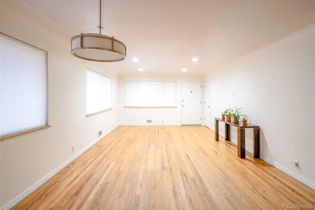 a view of a room with wooden floor and natural light