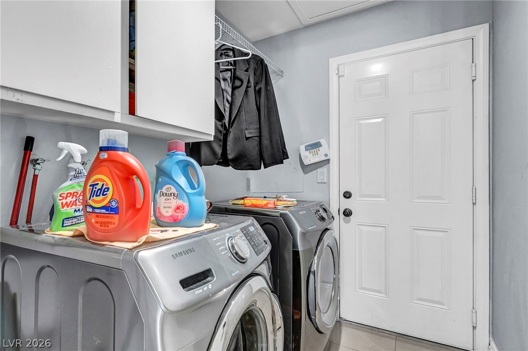 5882 Rio Tinto Way Las Vegas, NV 89110 - Photo 14 of 56 Functional laundry space featuring modern appliances and convenient overhead cabinetry.