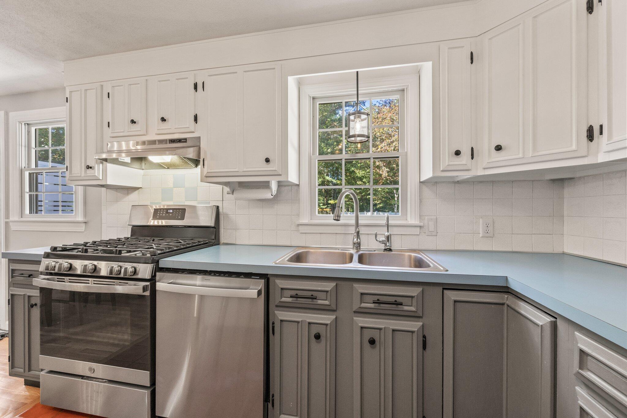 39 Maddaket Lane Centerville, MA 02632 - Photo 13 of 36 a kitchen with granite countertop a sink stainless steel appliances and white cabinets