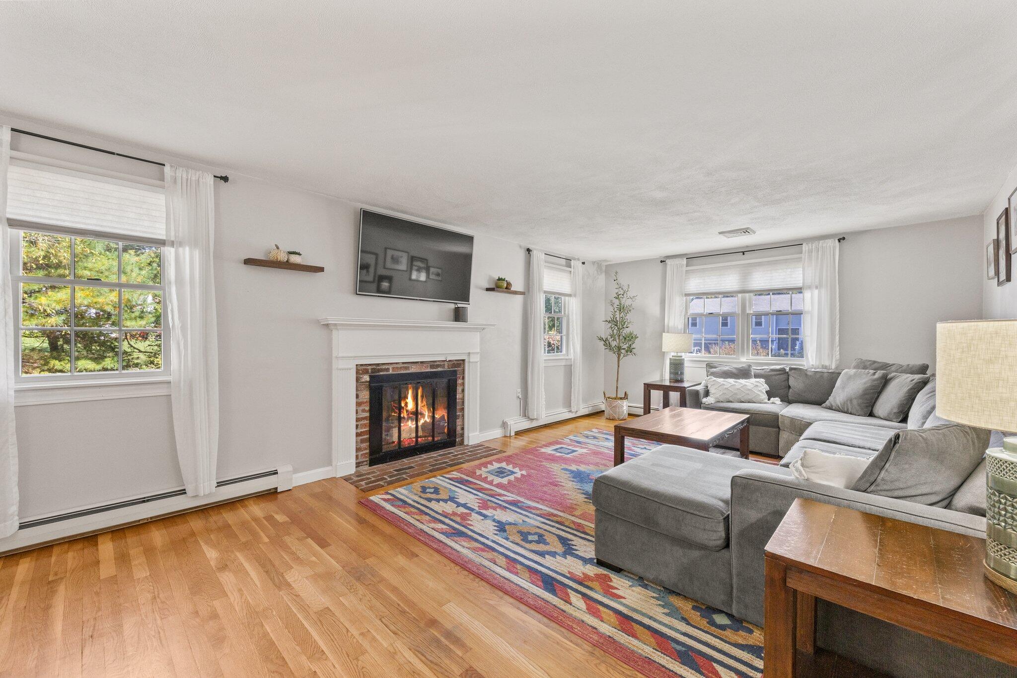 39 Maddaket Lane Centerville, MA 02632 - Photo 16 of 36 a living room with furniture a fireplace and a flat screen tv