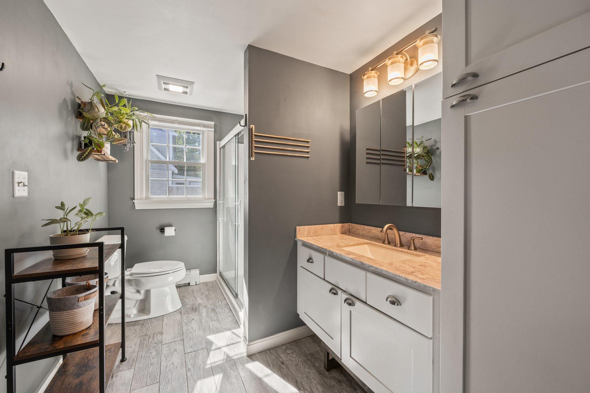 39 Maddaket Lane Centerville, MA 02632 - Photo 21 of 36 a bathroom with a granite countertop sink a toilet and shower